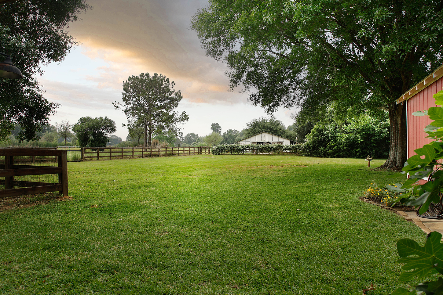 Side lawn with pasture view and barn in the distance