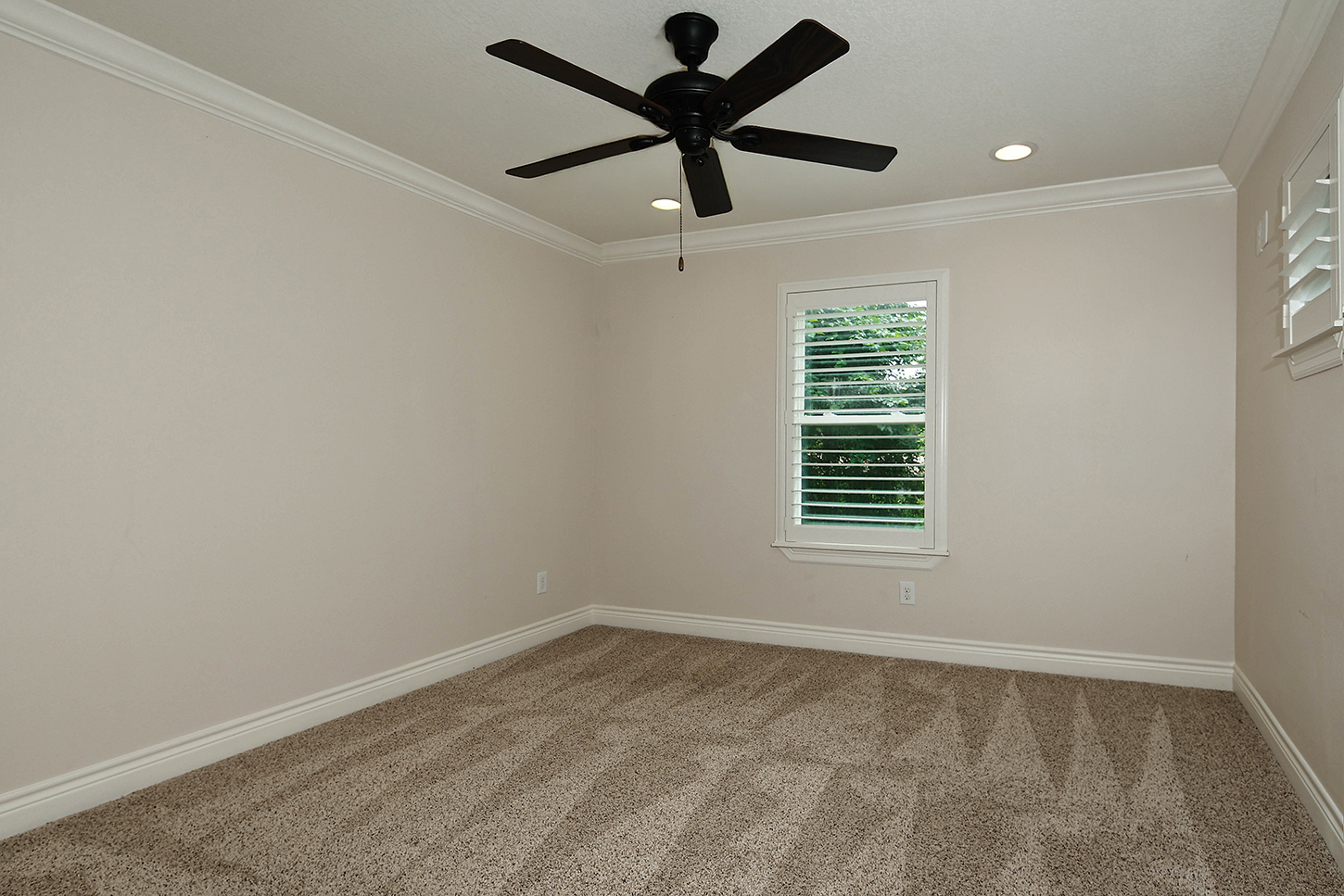 Additional upstairs bedroom with shuttered windows