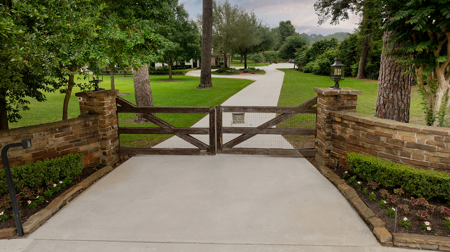 Gated brick and wood driveway entrance to the estate