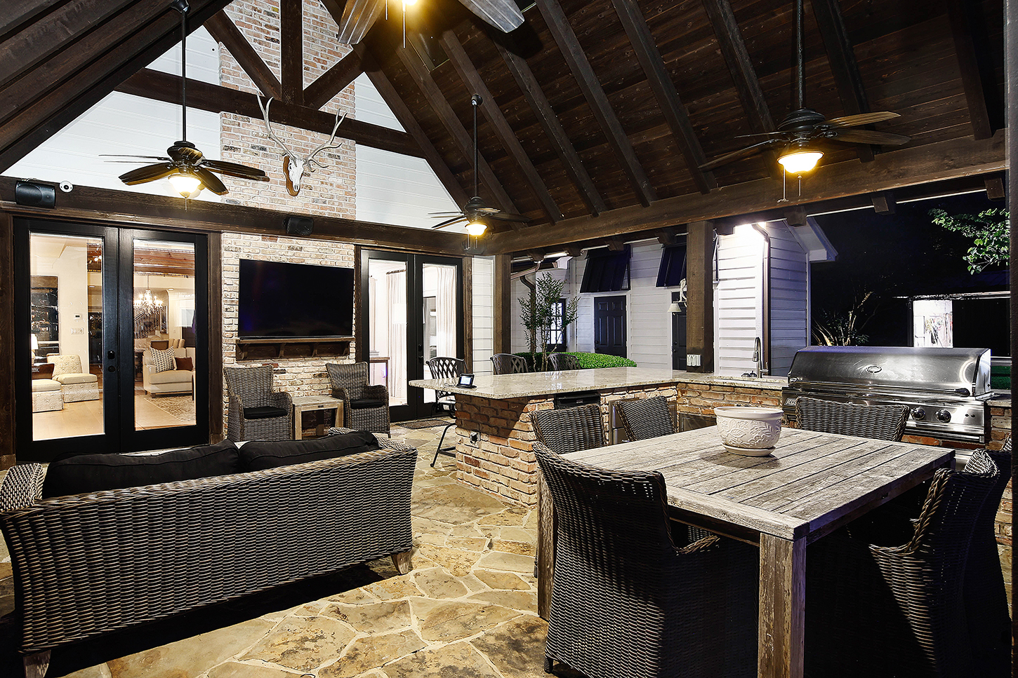 Pavilion interior with vaulted ceiling, fireplace, and outdoor kitchen