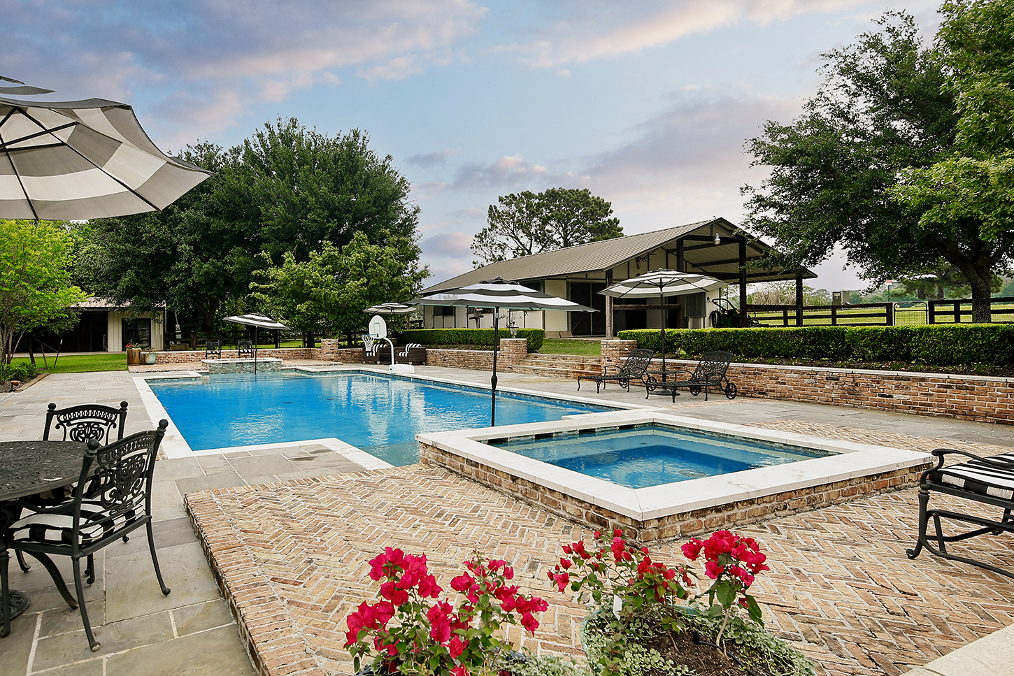Pool and raised spa with the stable in the background
