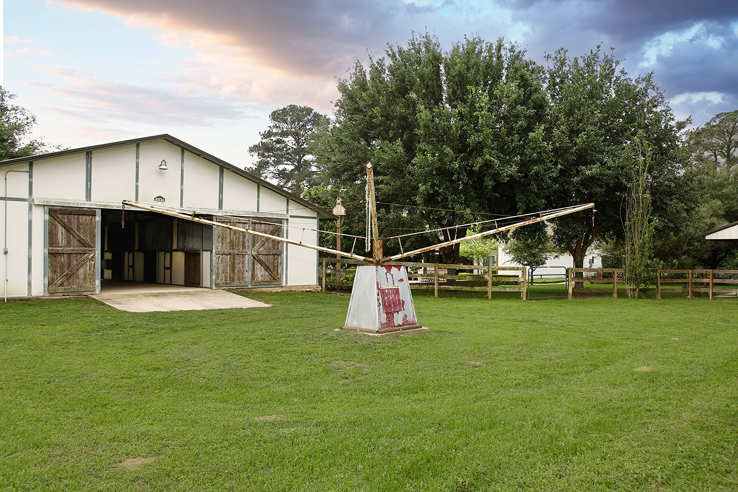 Horse stable exterior with fenced pasture