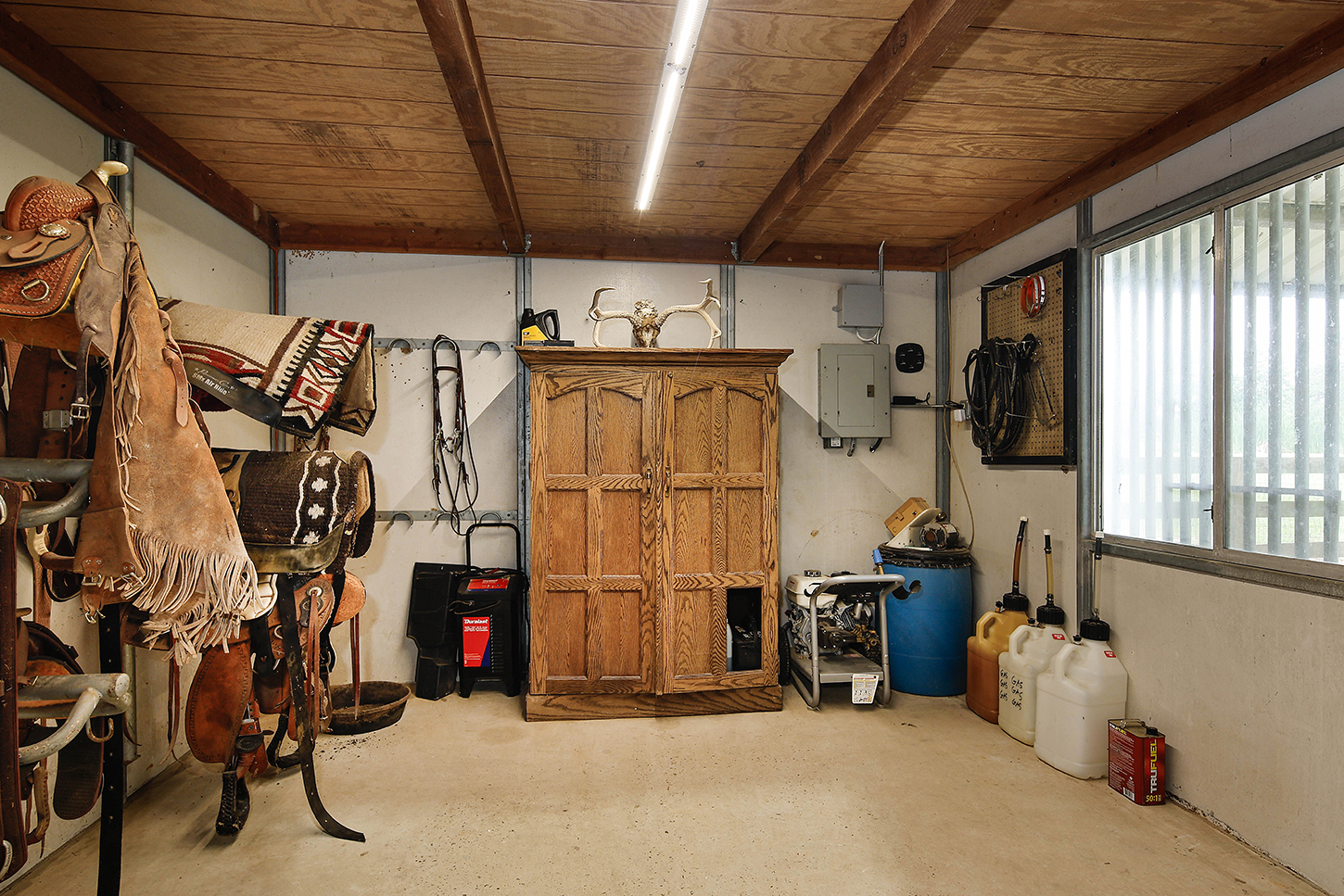 Tack room with saddle storage and horse gear