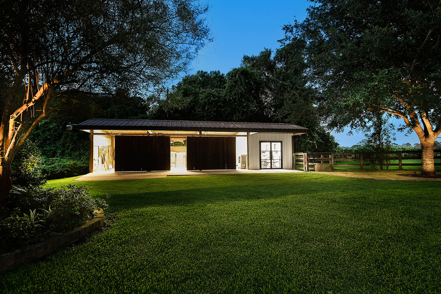 Twilight exterior of the outbuilding beside the main house grounds