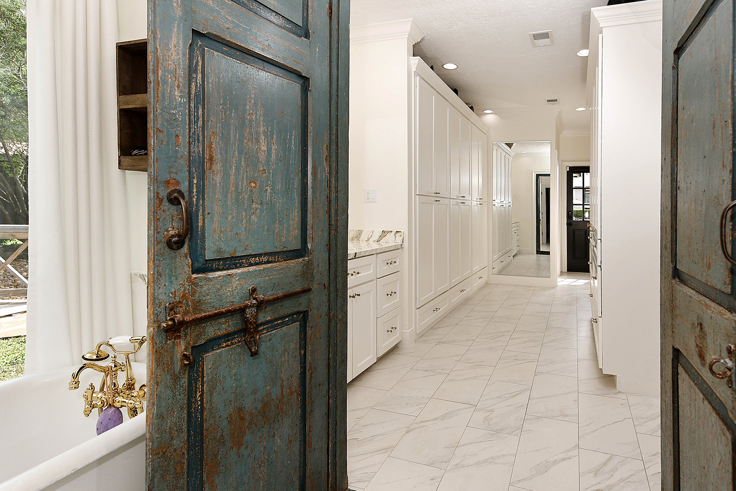 Primary bath entry with antique blue doors