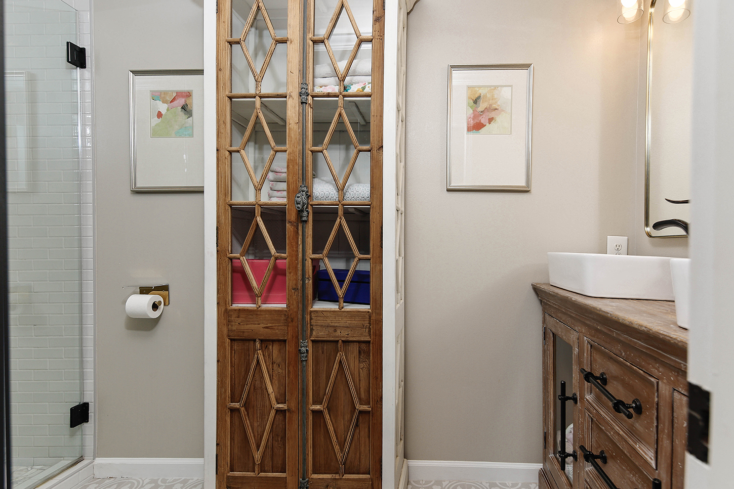 Bathroom with vintage-style linen cabinet and walk-in shower