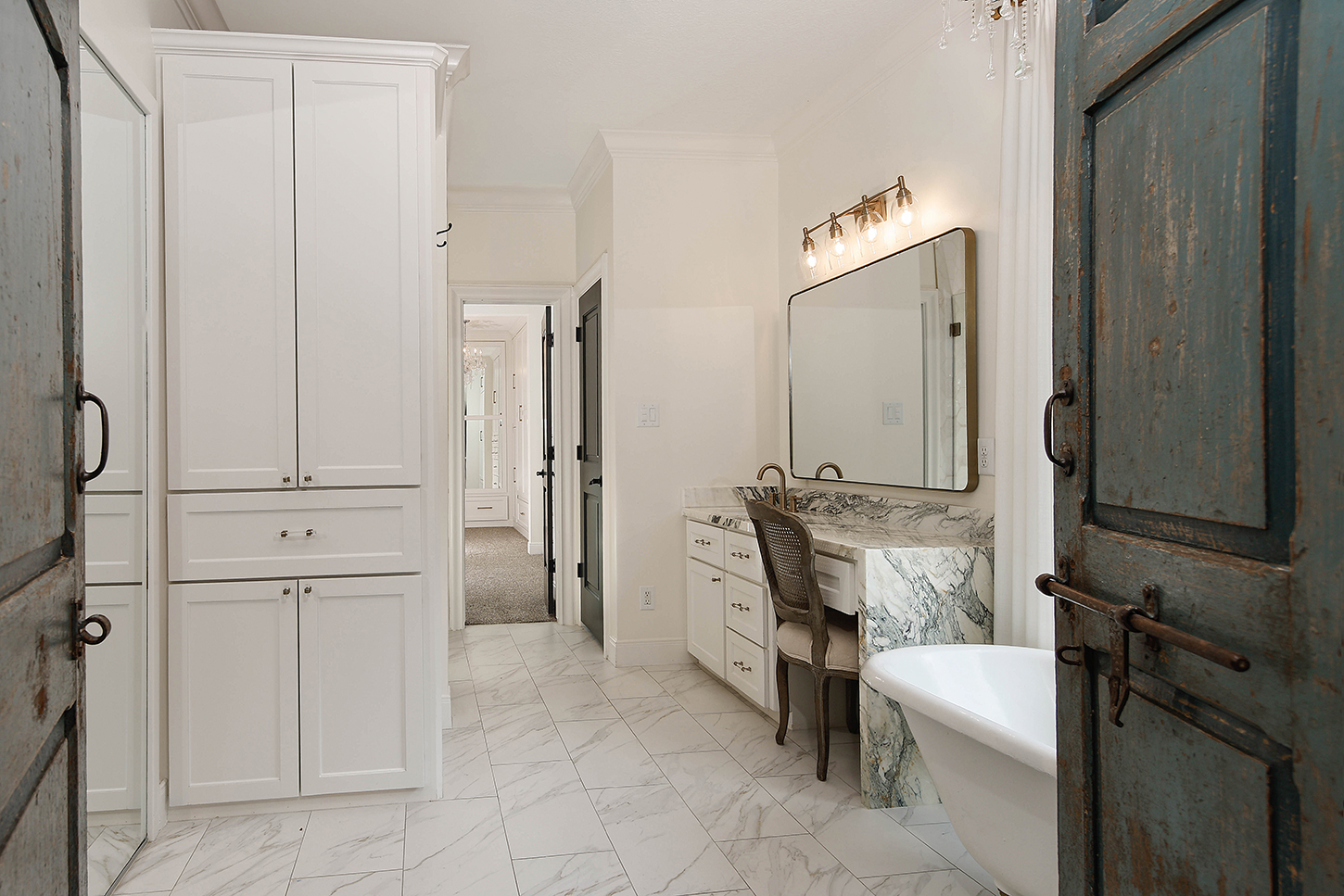 Primary bath with freestanding tub and marble vanity