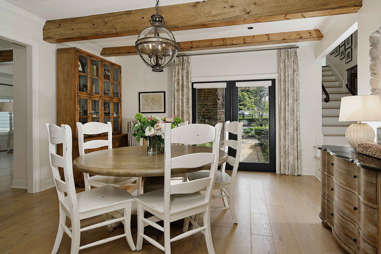 Breakfast room with antique china cabinet and lantern pendant