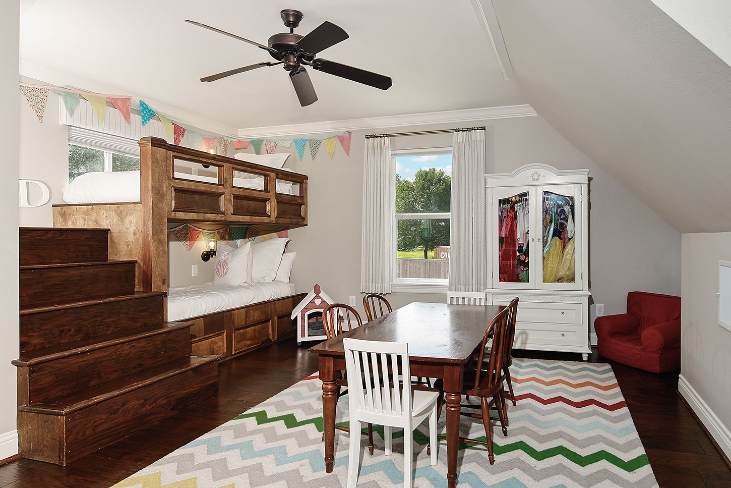 Bunk room with play table and custom built-in beds
