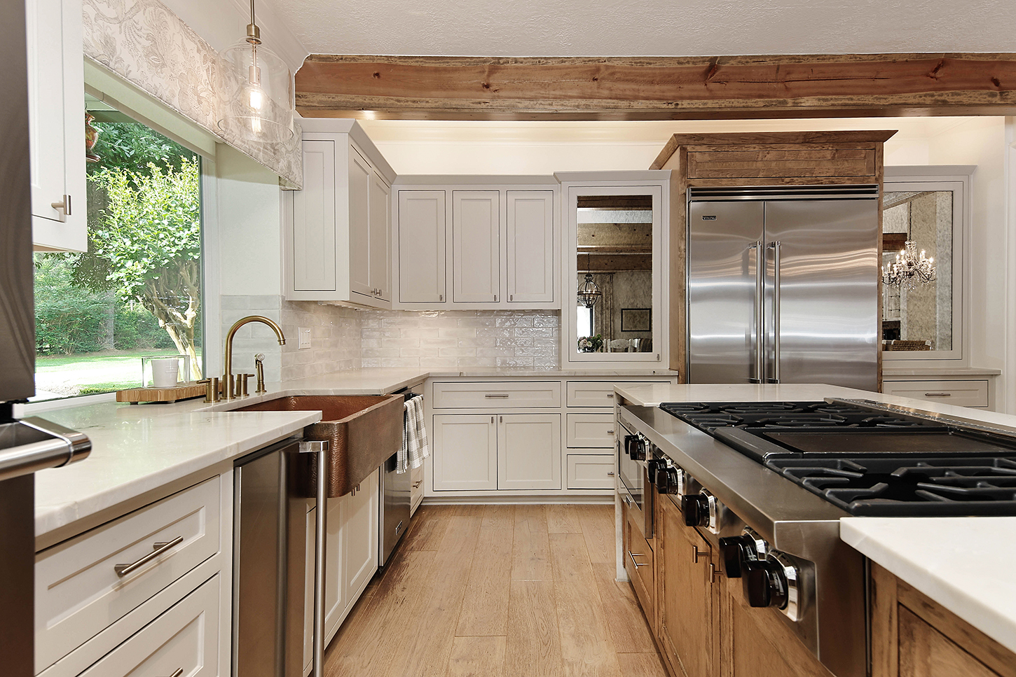 Kitchen with hammered copper farmhouse sink and brass faucet