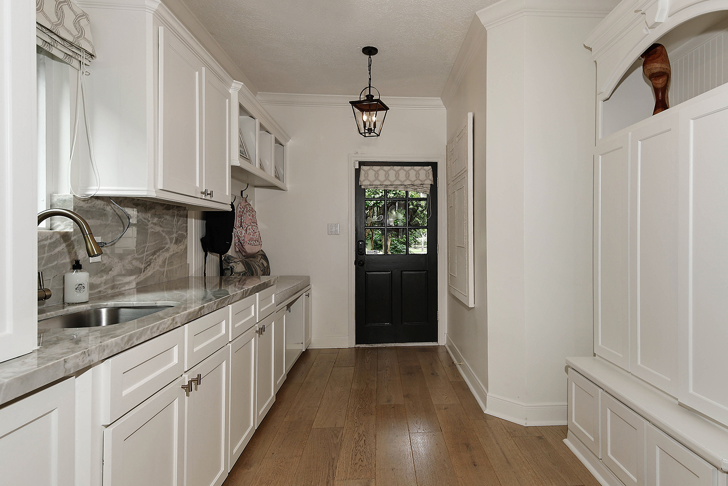Mudroom with marble counters and lantern pendant