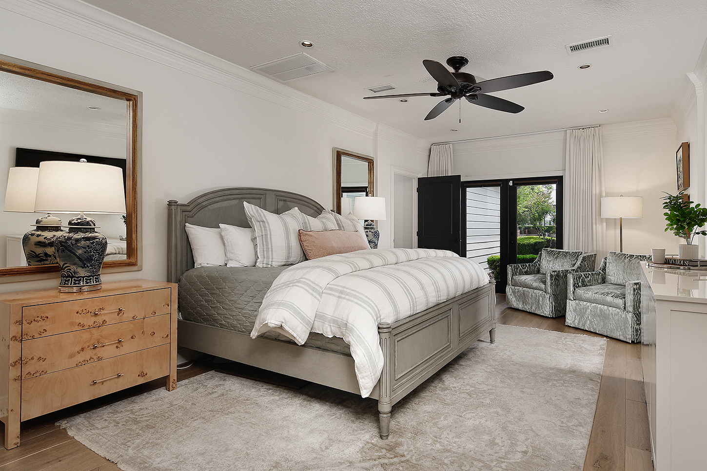 Primary bedroom with sitting area and patio access