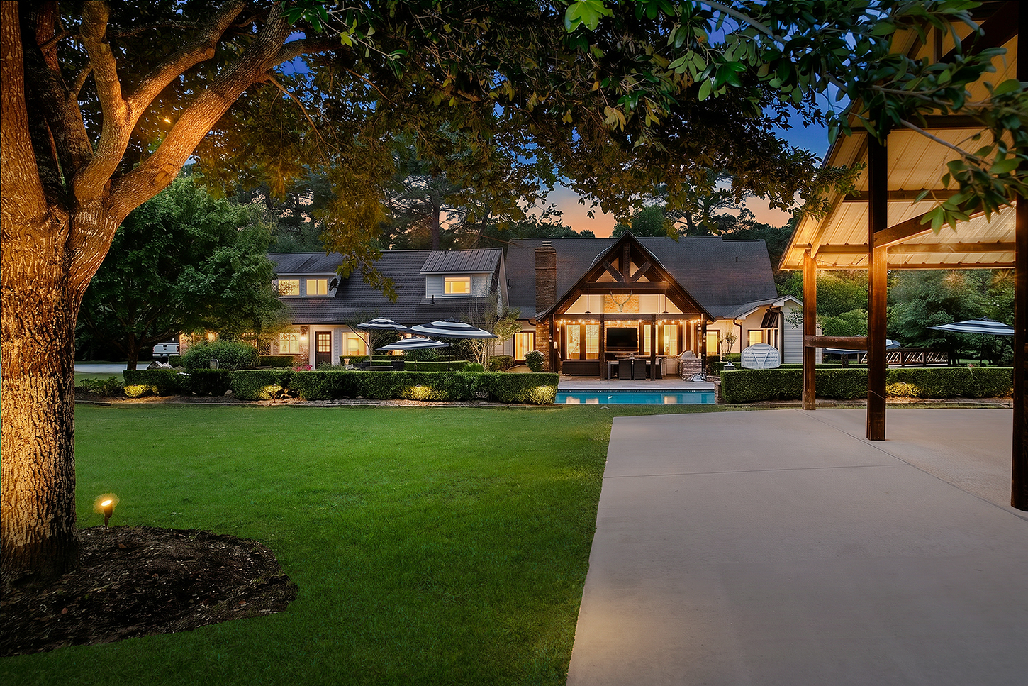 Rear view of the main house and pavilion at twilight across the lawn
