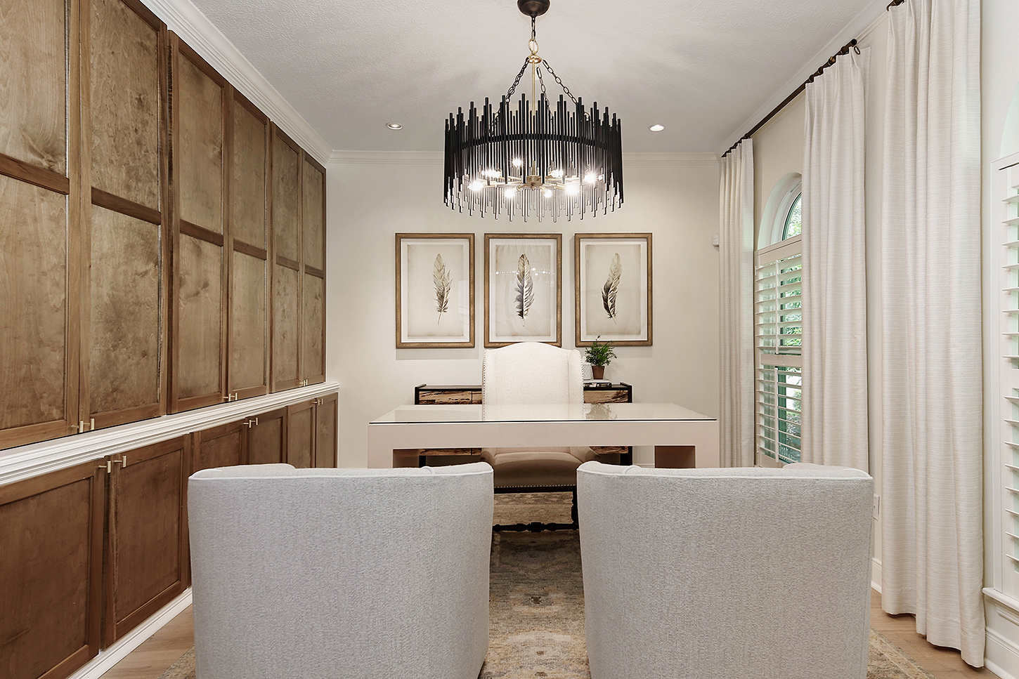 Wood-paneled study with chandelier and built-ins